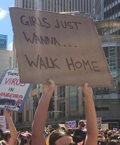 a group of people holding up signs in the air