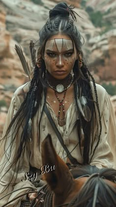 native american woman sitting on top of a horse