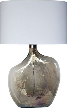 a glass table lamp with a white shade on the top and bottom part of it