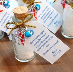 two cups with candy canes in them sitting next to each other on a table