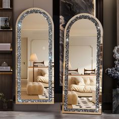 a large mirror sitting on top of a wooden floor next to a living room filled with furniture