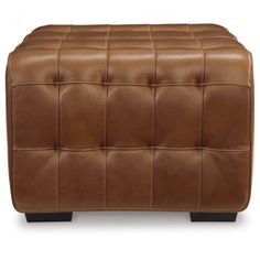 a brown leather ottoman with black legs and buttons on the bottom, in front of a white background