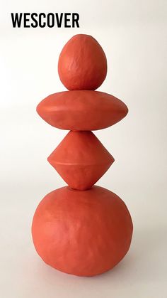 a stack of rocks sitting on top of each other in front of a white background