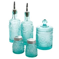 four blue glass jars with lids and spoons