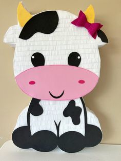 a paper plate cow with a bow on its head