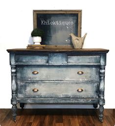 an old dresser painted blue with gold knobs