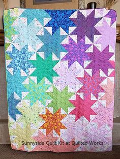 a multicolored quilt with stars on it