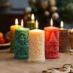 three colorful candles sitting on top of a table