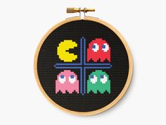 a cross stitch pattern with four pacman characters