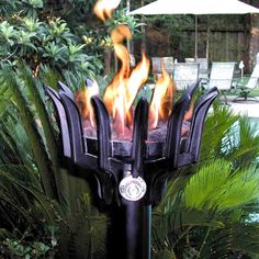 a fire pit in the middle of a garden