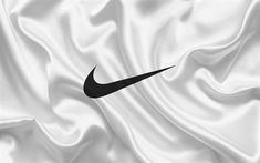 a black nike logo on a white satin background that looks like it is waving in the wind