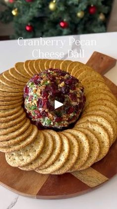 cranberry pecan cheese ball on a platter with crackers