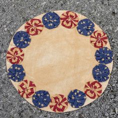 a round rug with red, white and blue stars on it sitting on the ground