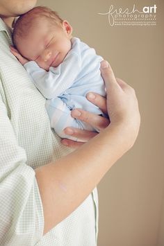 a man holding a baby in his arms