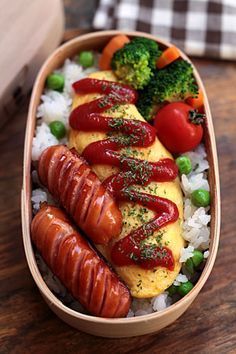 two hotdogs with ketchup on top of rice and broccoli