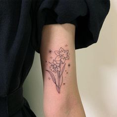 a woman's arm with a flower tattoo on the left side of her arm