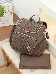 a brown purse sitting on top of a white bench