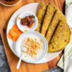 the meal is prepared and ready to be eaten on the wooden table with utensils