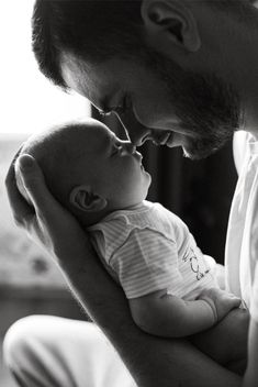 a man holding a baby in his arms