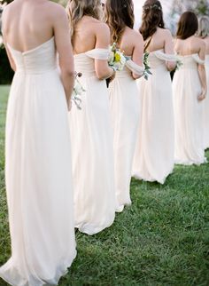 the bridesmaids are all wearing white dresses