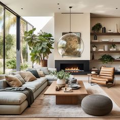 a living room filled with furniture and a fire place in the middle of the room