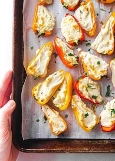 a tray filled with stuffed peppers covered in cheese