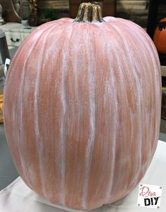 an orange pumpkin sitting on top of a table