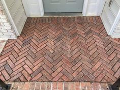 a brick walkway in front of a door