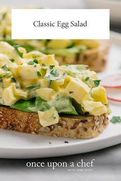 two pieces of bread with avocado and cheese on them sitting on a plate