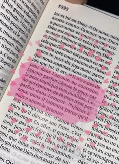 an open book with pink ink on it and the words written in french are shown