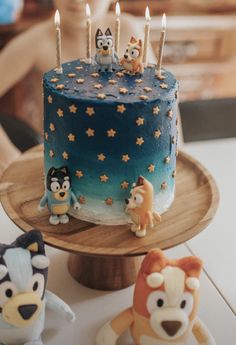 a birthday cake decorated with animals and candles