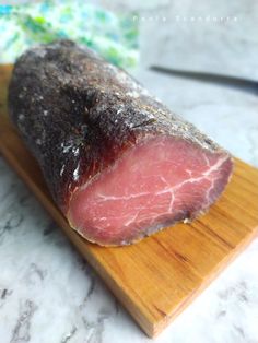 a piece of meat on a wooden cutting board