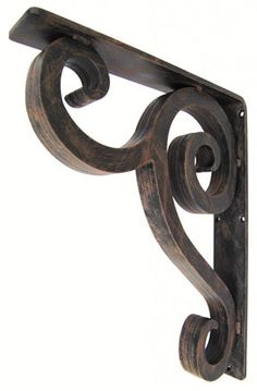 an iron shelf bracket with scroll design on the top and bottom, against a white background