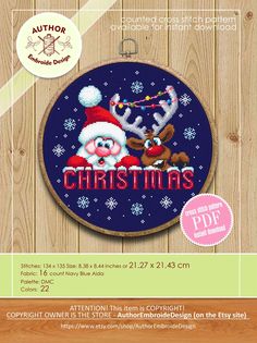 a cross stitch pattern with santa claus and reindeers on it, in front of a wooden