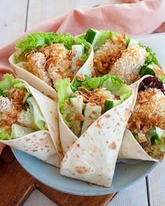 a plate filled with burritos on top of a wooden table