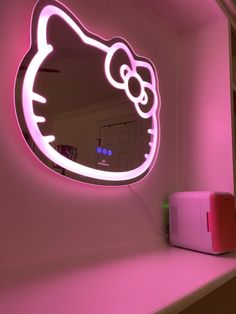 a pink hello kitty mirror sitting on top of a counter