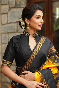 Rich fabric, a trendy back, and a stylish cut, it has all the right elements that make a perfect blouse. The attention to detail further enhances it and gives the blouse a great finish.From planning a distinct look for a new saree to upcycling an old saree, this blouse is your perfect companion as it can be paired with Collar Necks For Blouses, Collared Blouse Designs, Silk Choli Designs Blouses, Black Blouse Work Designs, Black Silk Blouse Designs, Collar Neck Design For Blouse, Collar Neck Blouse Pattern, Silk Sari Blouse Design, Blouse Design With Collar Neck