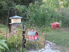 two bird houses in the middle of a garden