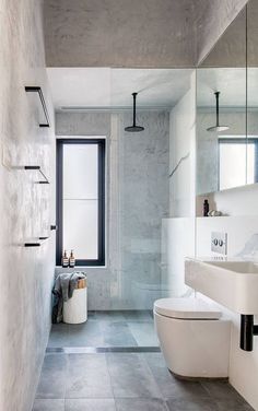 a bathroom with a white toilet sitting next to a sink