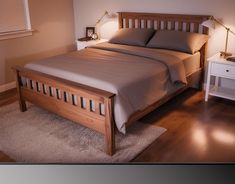 a bedroom with a bed, night stand and two nightstands on either side of the bed