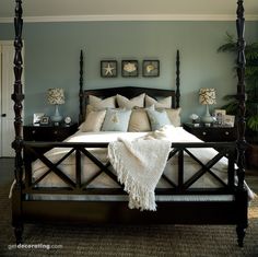 a bedroom with a four post bed and blue walls