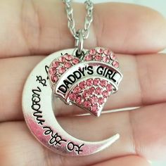 New Handmade Daddy's Girl Charm Necklace Celebrate Your Special Bond With This Beautiful Handmade Necklace. Silver Plated Pink Crystal 'Daddy's Girl' Charm With An Engraved 'To The Moon And Back' Crescent Moon Charm. 18 Inch Chain With Lobster Clasp Closure. Ships Within 24 Hours Of Purchase Monday-Saturday Daughter Gift, Daughter Christmas, Daughter Jewelry, Daughter Birthday, Father Daughter Personalized Pink Jewelry For Christmas, Cute Silver Jewelry For Mother's Day, Cute Silver Jewelry For Birthday Gift, Personalized Pink Jewelry For Father's Day, Cute Silver Jewelry For Gifts, Silver Jewelry For Personalized Cute Gifts, Cute Silver Jewelry For Personalized Gift, Silver Necklace For Birthday And Christmas, Jewelry Daughter