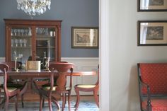 a dining room table with chairs and a chandelier