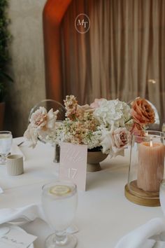 the table is set with flowers and candles