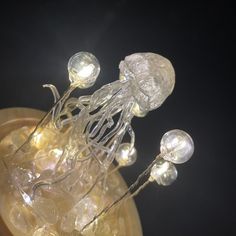 an image of jellyfish on display in a glass vase with some lights around it