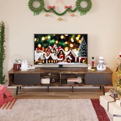 a living room with christmas decorations on the wall and a flat screen tv in the center