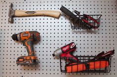 some tools are hanging on a peg board