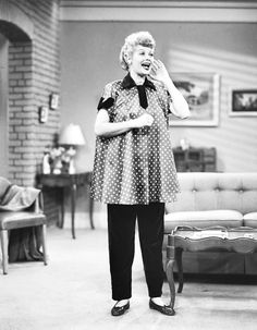 an old black and white photo of a woman in a polka dot dress talking on the phone