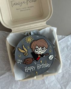 a harry potter pin sitting in a box