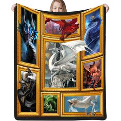 a woman is holding up a blanket with pictures of dragon's